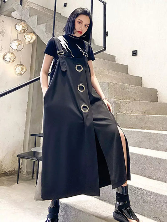 black overall dress with silver hardware and irregular slit